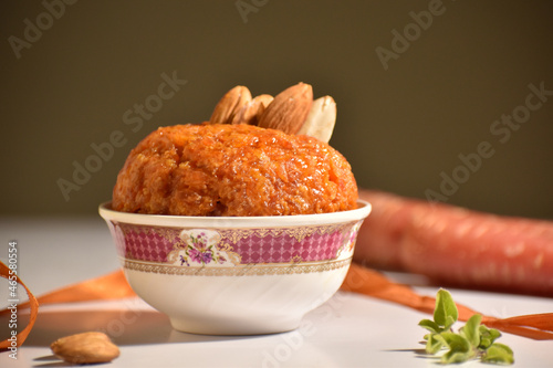 Selective focus picture of Indian Traditional sweet called Carrot Halwa with background blur photo