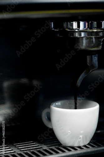 Coffee cup on a coffee machine at a coffee shop. Still details. High quality photo