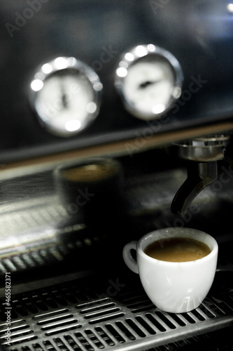 Coffee cup on a coffee machine at a coffee shop. Still details. High quality photo