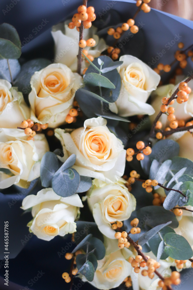 Fototapeta premium yellow roses with eucalyptus and berries