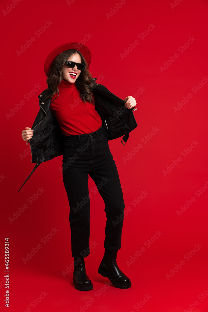 White woman in leather jacket laughing while dancing on camera White woman in leather jacket laughing while dancing on camera