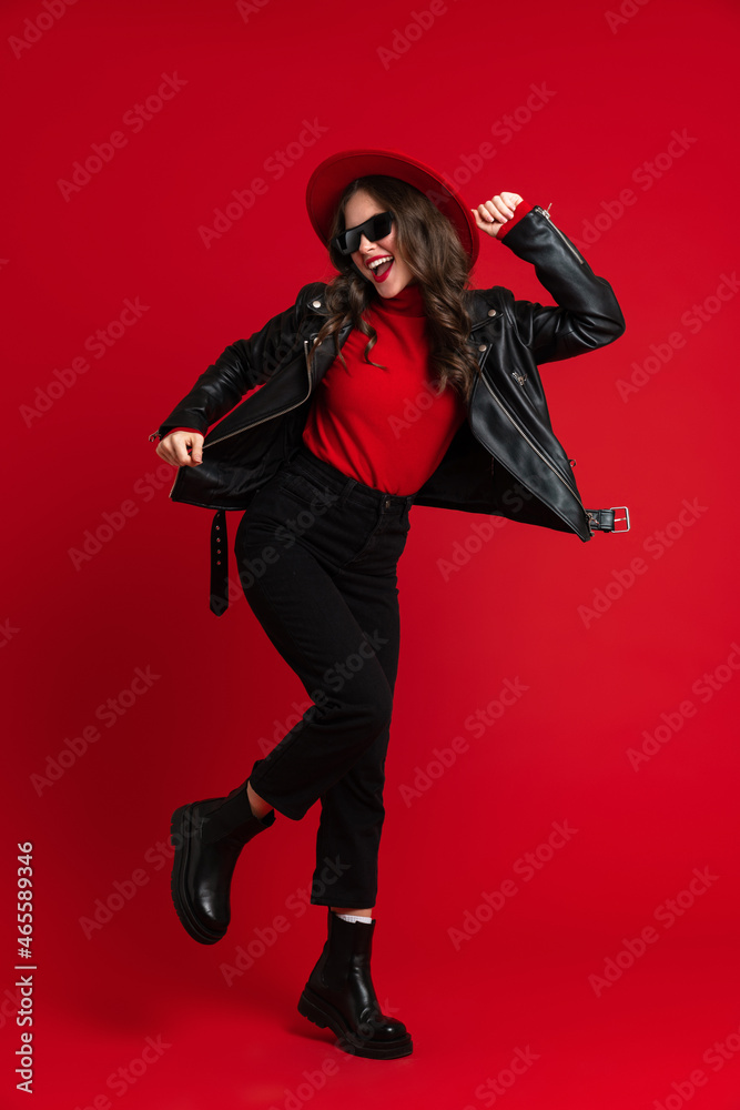 White woman in leather jacket laughing while dancing on camera White woman in leather jacket laughing while dancing on camera