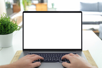 Man working on a laptop with a blank screen at his desk - POV - point of view perspective