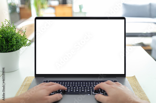 Man working on a laptop with a blank screen at his desk - POV - point of view perspective