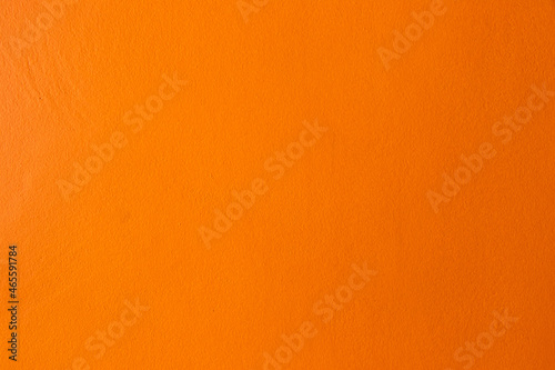 Orange color of grunge concrete textured background with copy space