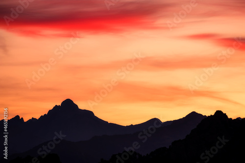 Sunrise over the silhouetted peak of Paglia Orba mountain in Corsica