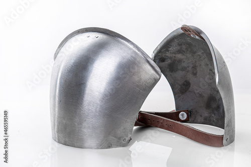Steel metal shoulder pads to protect torso. Iron steel ammunition, personal accessories for a knight: helmet, chain mail, limb protection. concept is a reconstruction of battles. photo