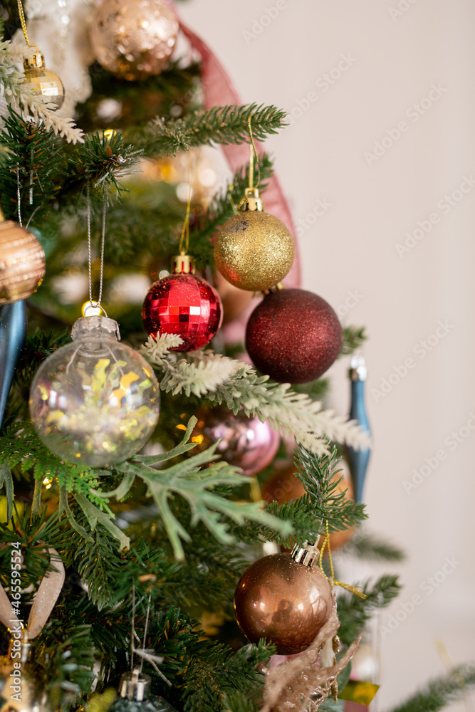 Christmas tree decorated with beautiful balloons and ribbons. Artificial spruce with decorative toys. Concept - Christmas weekend