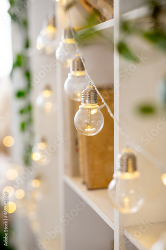 Christmas lights garlands for Christmas tree decoration.Artificial spruce with decorative toys. Concept - Christmas weekend