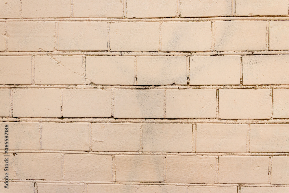 Obraz premium Old Wall Made Of Red Brick, Painted White In Loft Style. Background of white building bricks. Wall is made of white building blocks with elements cement and putty. Textured vintage light background