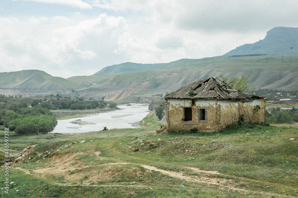 Rustic landscape abandoned farm with green grass in summer. old crumbling fence is a corral for cows and horses. concept is cattle breeding. Rustic landscape abandoned farm with green grass in summer. old crumbling fence is a corral for cows and horses. concept is cattle breeding.