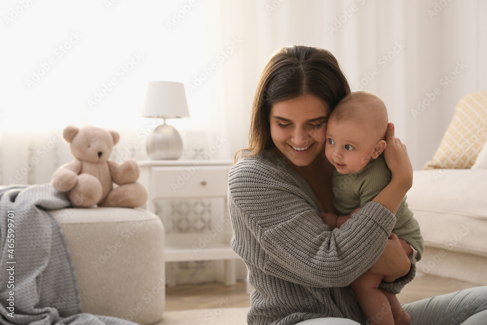 Young woman with her little baby on floor at home Young woman with her little baby on floor at home