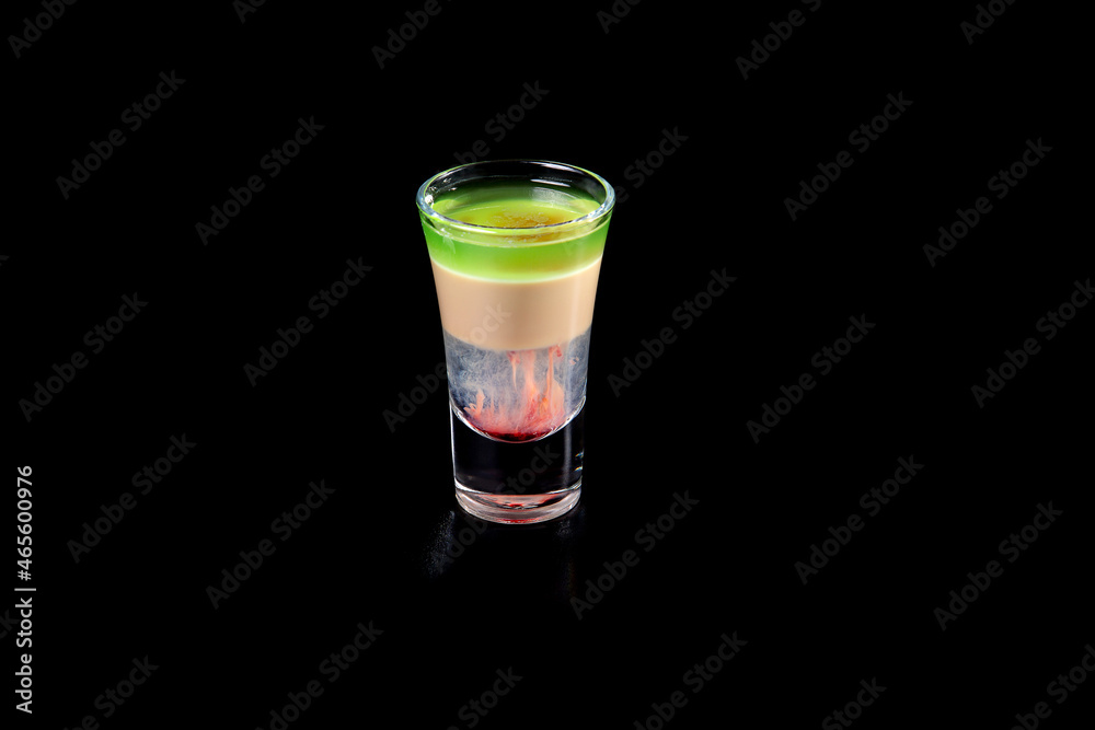 aperitif is an alcoholic cocktail made from various ingredients. Cocktail - one glass on a black background. concept is a holiday party. aperitif is an alcoholic cocktail made from various ingredients. Cocktail - one glass on a black background. concept is a holiday party.