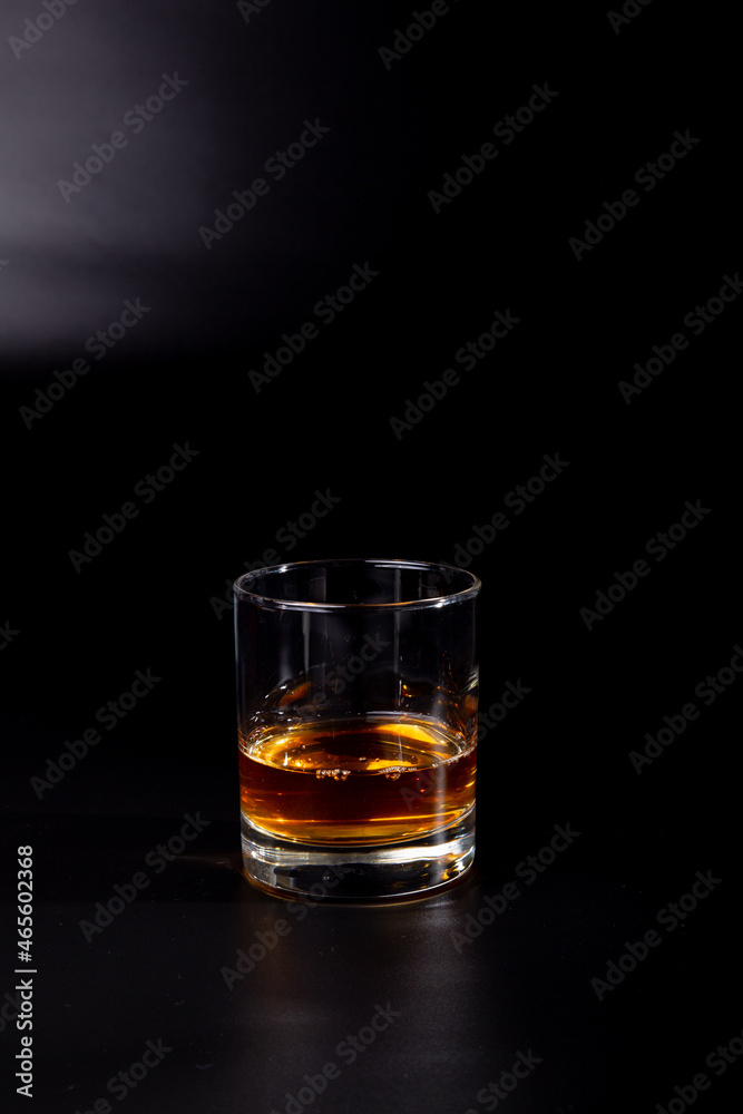 aperitif is an alcoholic cocktail made from various ingredients. Cocktail - one glass on a black background. concept is a holiday party. aperitif is an alcoholic cocktail made from various ingredients. Cocktail - one glass on a black background. concept is a holiday party.