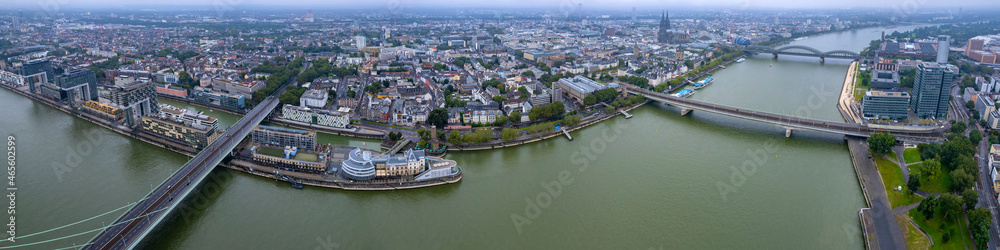 Aerial panorama view of the old town of cologne on a rainy, cloudy and foggy morning in summer.