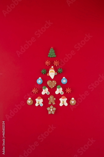 Christmas tree of cookies on the red background. Christmas holiday creative concept.
