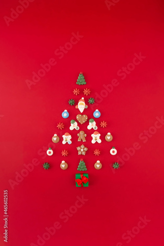 Christmas tree of cookies on the red background. Christmas holiday creative concept.