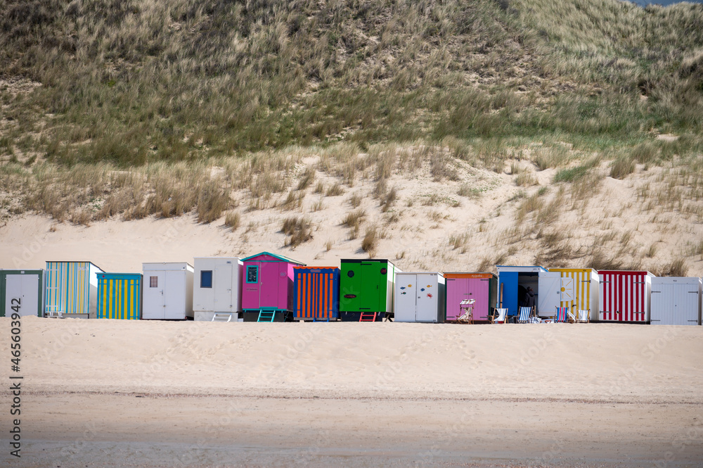 Small beach huts on white sandy beach North sea beach near Zoutelande, Zeeland, Netherlands