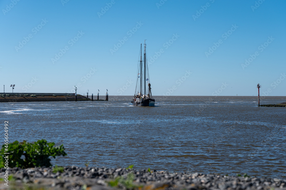 Walking on beach of Harlingen fisherman town on Wadden sea, Friesland, Netherlands at low tide Walking on beach of Harlingen fisherman town on Wadden sea, Friesland, Netherlands at low tide