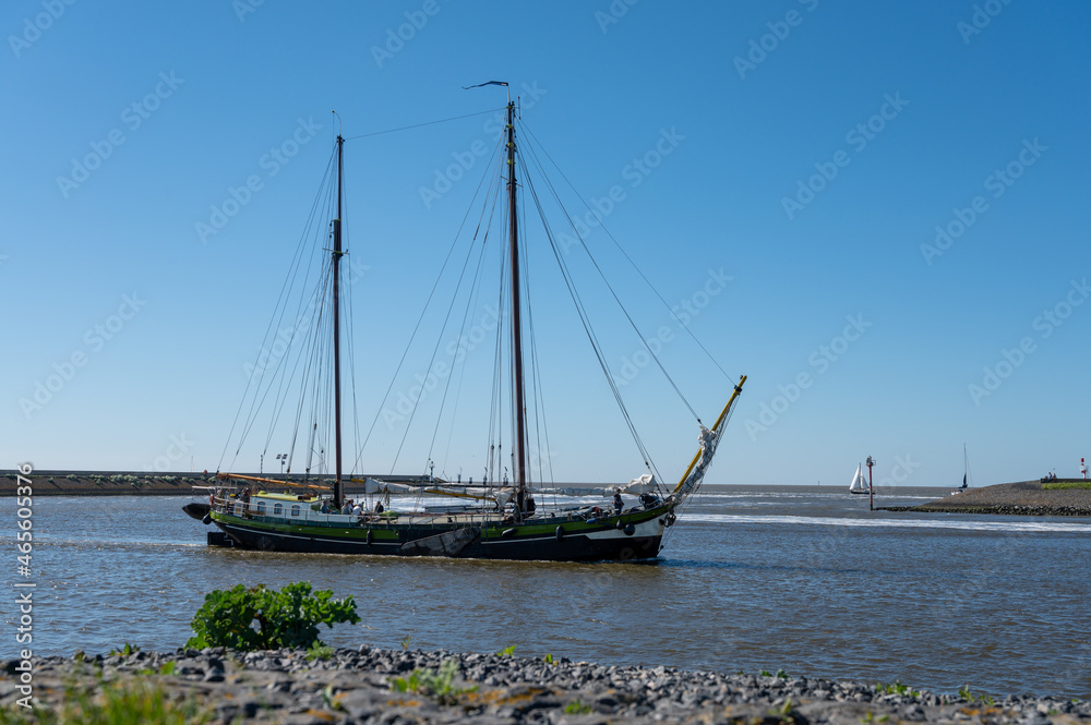 Walking on beach of Harlingen fisherman town on Wadden sea, Friesland, Netherlands at low tide