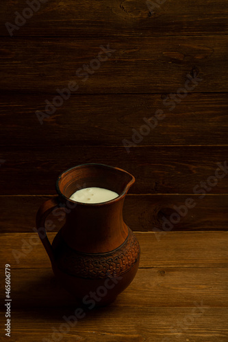 large clay jug with fresh milk and cream. Fresh ingredients for cheese production. concept is cheese handicraft production, restaurant.