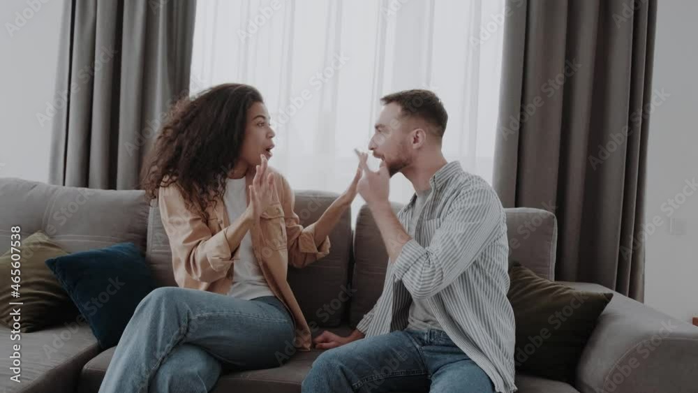 Expressively gesturing. Swearing couple having quarrel about their life together Expressively gesturing. Swearing couple having quarrel about their life together