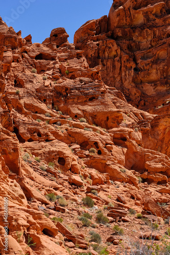 Erosion created small holes and caves in the Red Aztec Sandstone in the Nevada Desert