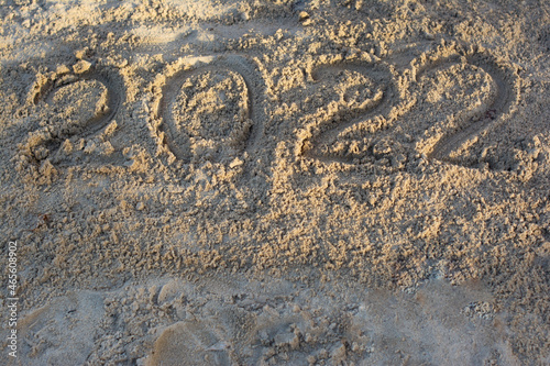 it says 2022 in the sand. Flat lay, top view, copy space.