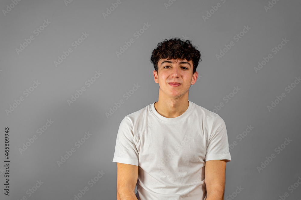 Portrait of the young happy smiling man isolated on a gray background Portrait of the young happy smiling man isolated on a gray background