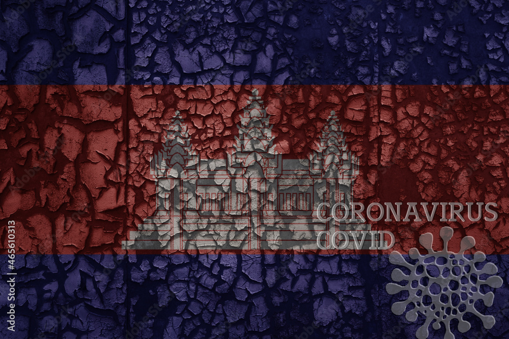 flag of cambodia on a old metal rusty cracked wall with text coronavirus, covid, and virus picture.