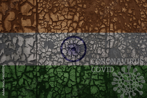 flag of india on a old metal rusty cracked wall with text coronavirus  covid  and virus picture.