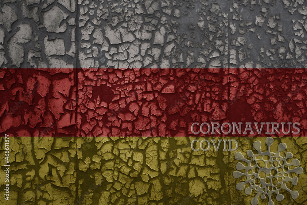 flag of south ossetia on a old metal rusty cracked wall with text coronavirus, covid, and virus picture.