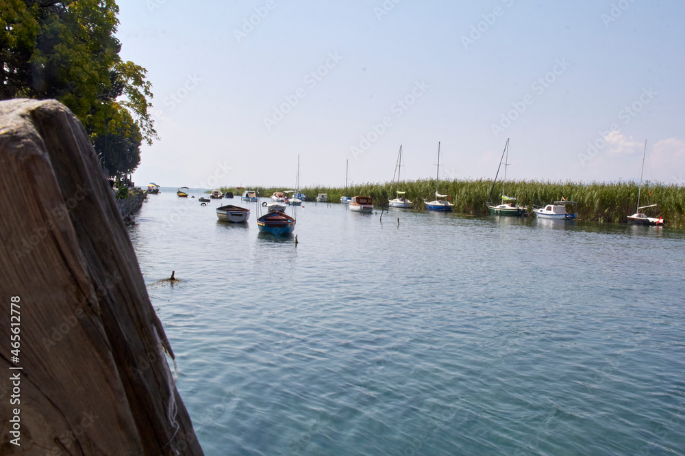 Harbor on a lake, boats, marine plants, ships, boats, boats, wooden bridge, running water, vegetation,