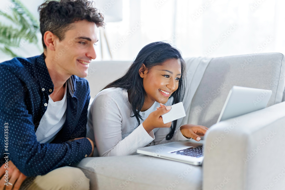 Young couple relaxing on sofa with laptop Young couple relaxing on sofa with laptop