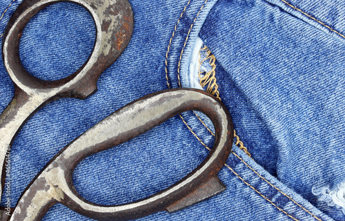 an old pair of scissors in jeans background