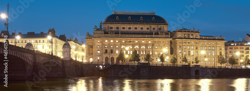 Beautiful Prague at night. Illuminated National Theater with reflection in Vltava river.