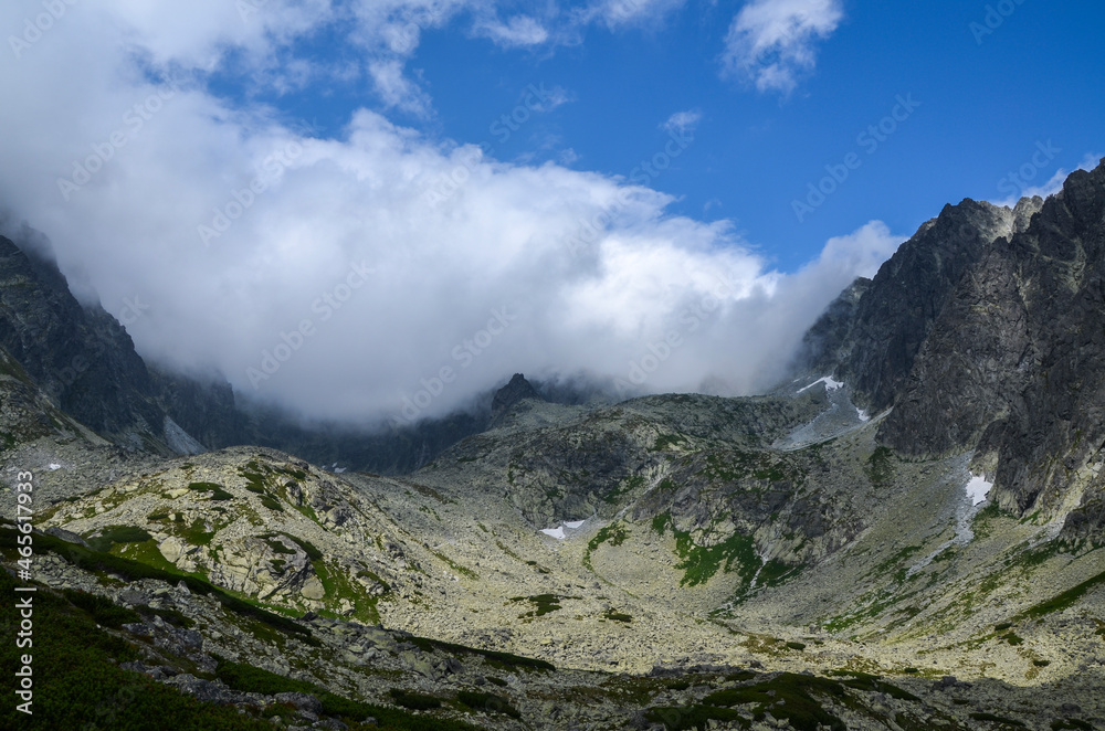 Obraz premium Mountain landscape in Slovakia, rocky mountain valley and climbing rocks with cloudy sky in the national park High Tatras