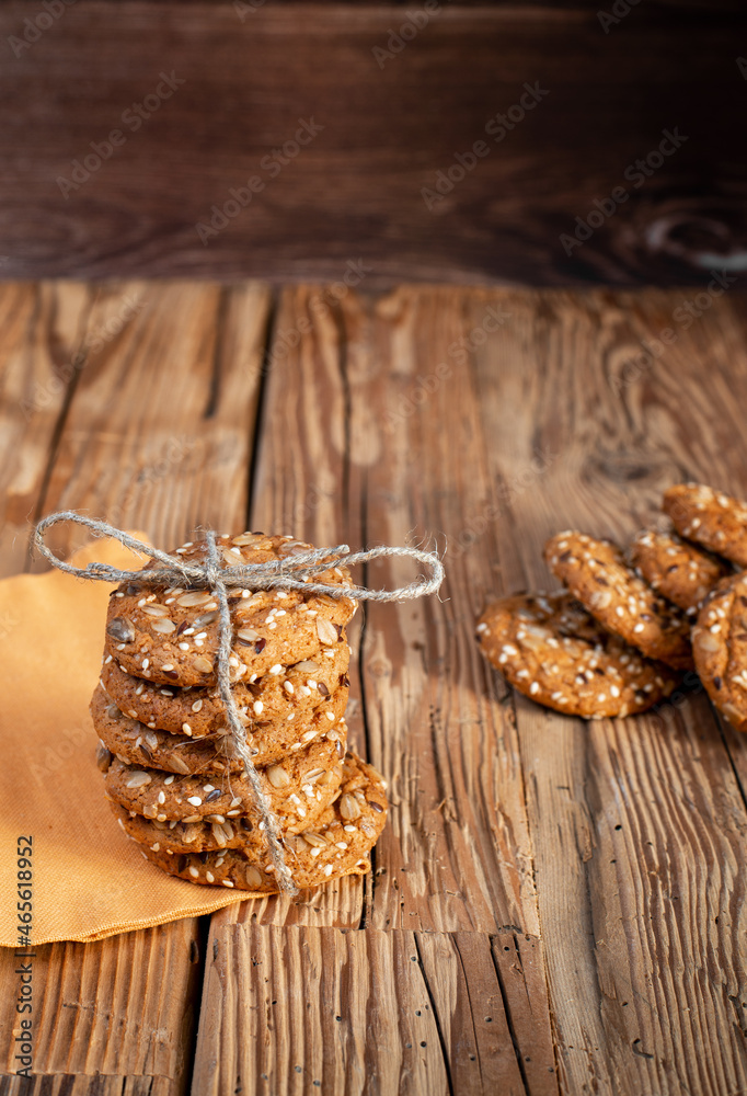 Fototapeta premium American cookie with seed pieces laid out in a stack on a wooden table.