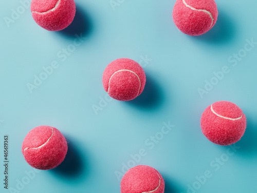 Pattern made with pink tennis balls on pastel pink background. Creative sport concept. Retro 80's or 90's aesthetic. Flat lay, top view. © Aleksandar