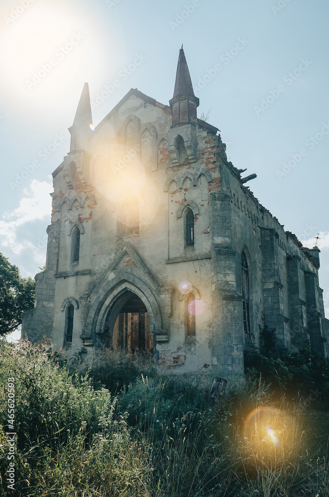 Ancient church on a background of blue sky. Sunbeams. Glare in the frame