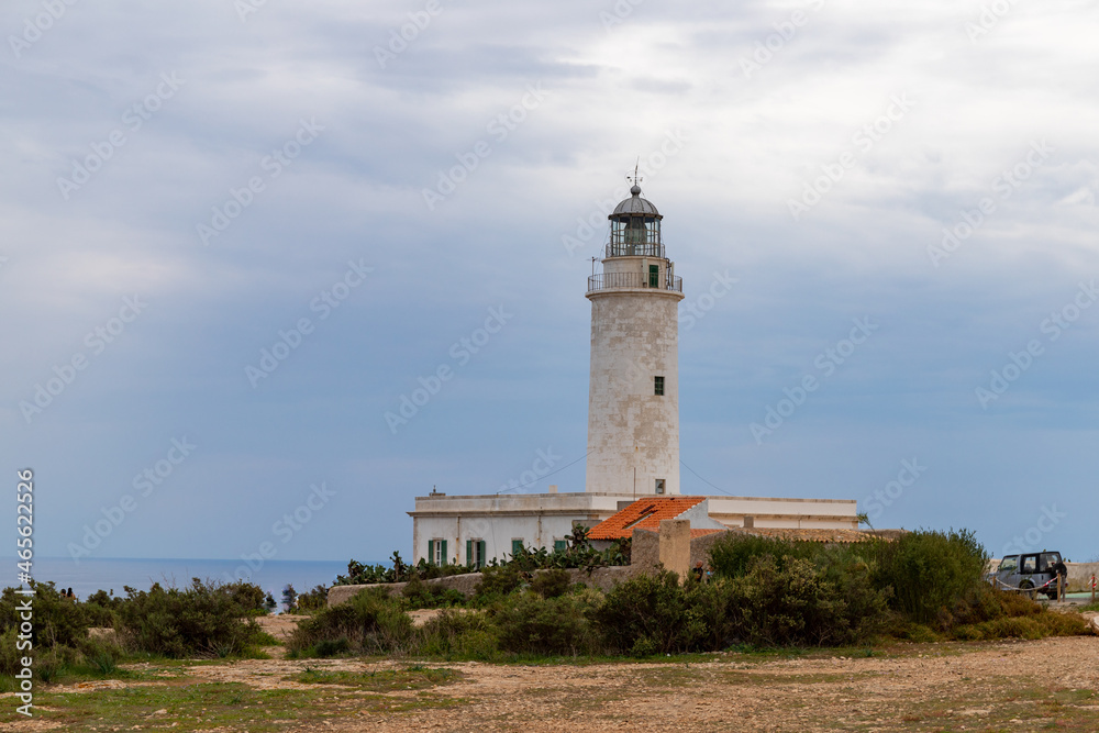 Far de la Mola, a lighthouse on the southeastern tip of the island of Formentera in the Balearic Islands, Spain - White lighthouse on the top of a cliff in the Mediterranean Sea