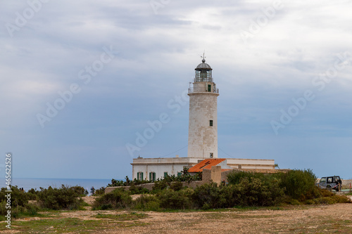 Far de la Mola, a lighthouse on the southeastern tip of the island of Formentera in the Balearic Islands, Spain - White lighthouse on the top of a cliff in the Mediterranean Sea © Irina