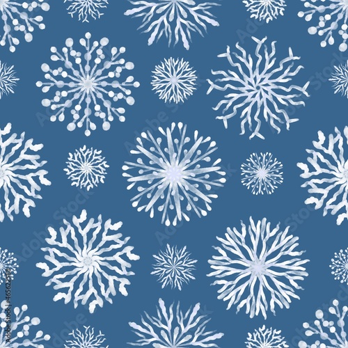 Christmas Seamless pattern of snowflakes on a blue background.