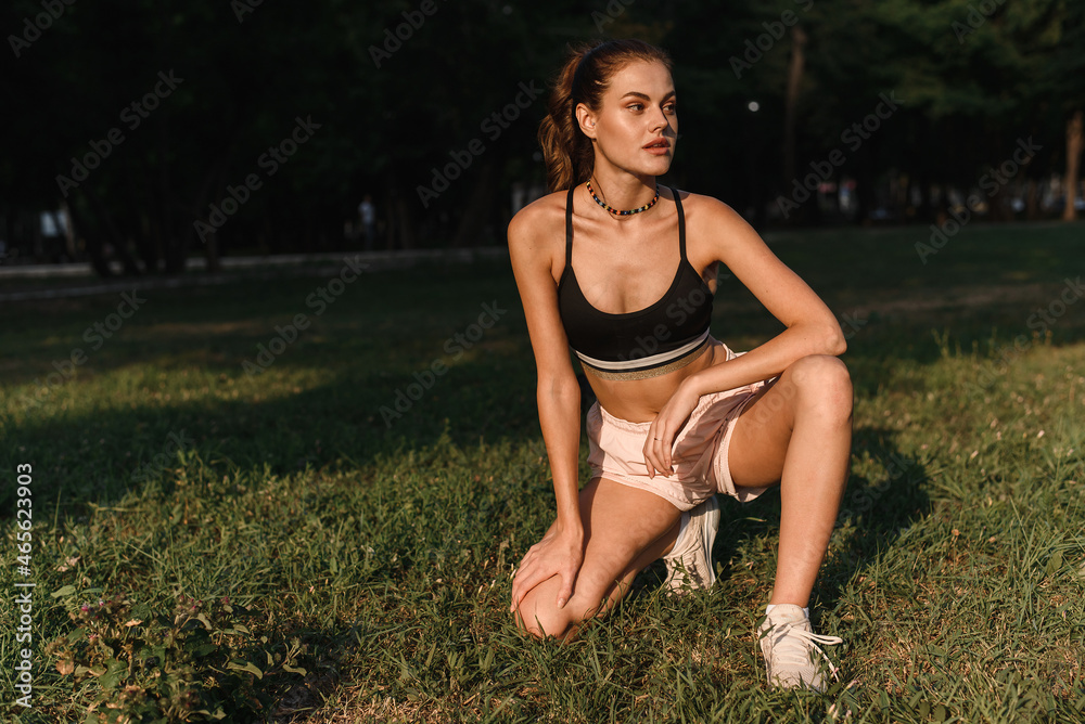 Portrait of a girl resting after outdoor workout. Take a break after yoga or stretching Portrait of a girl resting after outdoor workout. Take a break after yoga or stretching