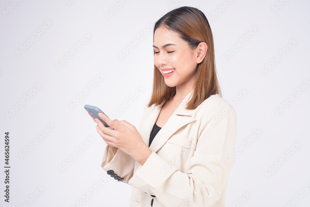 Portrait of young beautiful woman in suit using smart phone over white background. Portrait of young beautiful woman in suit using smart phone over white background.