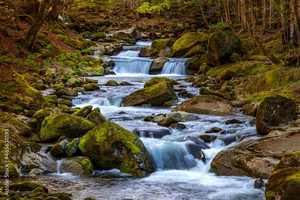 Beautiful autumn landscape of flowing cascade water in a mountain river Beautiful autumn landscape of flowing cascade water in a mountain river