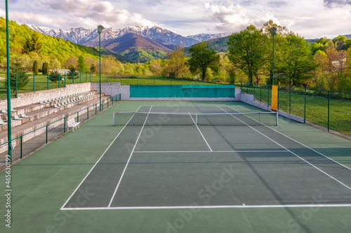 Tennis court. Trees and mountains around the tennis court in nature. © EdVal