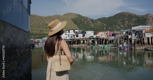 Travel woman look at the fishing village in Hong Kong photo