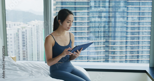 Woman sit on the bed and use of tablet computer Free Download Woman sit on the bed and use of tablet computer - GFXLoad