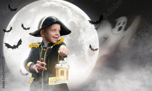 a boy in a pirate's carnal suit with a lantern in his hands and a ghost for Halloween. against the background of the moon and bats